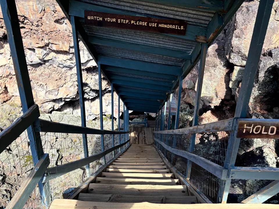 Stairs leading down into the Ice Cave at the base of Bandera Volcano